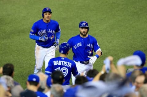 TORONTO, ON – OCTOBER 18: Kevin Pillar #11 of the Toronto Blue Jays celebrates with his teammate Jose Bautista #19 after hitting a sacrifice fly to right field to score Ezequiel Carrera #3 in the eighth inning against Mike Clevinger #52 of the Cleveland Indians during game four of the American League Championship Series at Rogers Centre on October 18, 2016 in Toronto, Canada. (Photo by Vaughn Ridley/Getty Images)