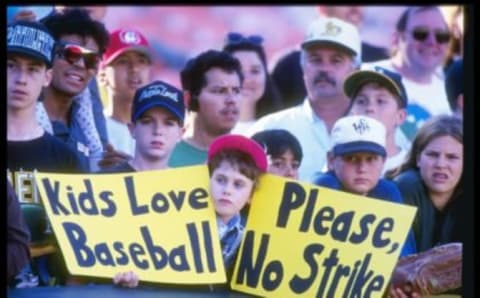 11 Aug 1994: Fan holds up a sign in protest of the baseball strike during a game between the Seattle Mariners and the Oakland Athletics at the Oakland Coliseum in Oakland, California. The Mariners won the game 8-1.