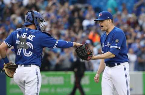 TORONTO, ON – SEPTEMBER 26: Ken Giles #51 of the Toronto Blue Jays celebrates their victory with Reese McGuire #70 during MLB game action against the Houston Astros at Rogers Centre on September 26, 2018 in Toronto, Canada. (Photo by Tom Szczerbowski/Getty Images)