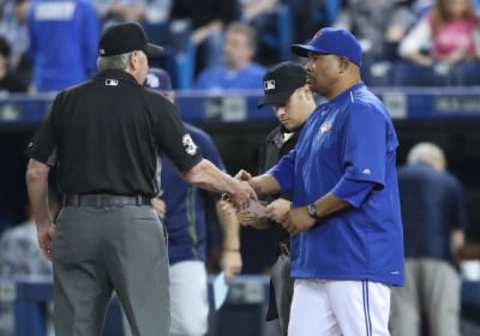 TORONTO, CANADA – MAY 17: Acting manager DeMarlo Hale #16 of the Toronto Blue Jays delivers the starting lineup to third base umpire Mike Winters #33 as he fills in for suspended manager John Gibbons #5 before the start of MLB game action against the Tampa Bay Rays on May 17, 2016 at Rogers Centre in Toronto, Ontario, Canada. (Photo by Tom Szczerbowski/Getty Images)