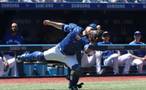 TORONTO, ON – JULY 8: Russell Martin #55 of the Toronto Blue Jays bobbles a foul pop up but holds on for the catch in the first inning during MLB game action against the New York Yankees at Rogers Centre on July 8, 2018 in Toronto, Canada. (Photo by Tom Szczerbowski/Getty Images)