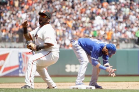 SAN FRANCISCO, CA – JUNE 05: Jose Bautista #19 of the Toronto Blue Jays and Pablo Sandoval #48 of the San Francisco Giants both react after Bautista stole third base in the fifth inning of their game against the San Francisco Giants at AT&T Park on June 5, 2013 in San Francisco, California. (Photo by Ezra Shaw/Getty Images)