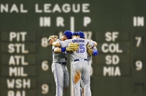 BOSTON, MASSACHUSETTS – JULY 16: Teoscar Hernandez #37 of the Toronto Blue Jays (back right), Randal Grichuk #15 of the Toronto Blue Jays (C) and Billy McKinney #28 of the Toronto Blue Jays embrace in the outfield after the victory over the Boston Red Sox at Fenway Park on July 16, 2019 in Boston, Massachusetts. (Photo by Omar Rawlings/Getty Images)