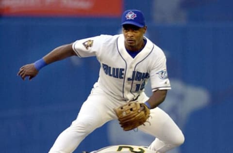 Toronto Blue Jays’ second baseman Homer Bush makes the double play on Oakland A’s left fielder Terrence Long during second inning American League play in Toronto, Canada, 15 August, 2001. AFP PHOTO/J.P. MOCZULSKI (Photo by J.P. MOCZULSKI / AFP) (Photo by J.P. MOCZULSKI/AFP via Getty Images)