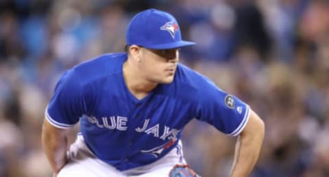 TORONTO, ON – APRIL 28: Roberto Osuna #54 of the Toronto Blue Jays looks in before delivering a pitch in the ninth inning during MLB game action against the Texas Rangers at Rogers Centre on April 28, 2018 in Toronto, Canada. (Photo by Tom Szczerbowski/Getty Images) *** Local Caption *** Roberto Osuna