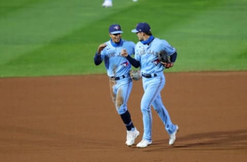 Sep 8, 2020; Buffalo, New York, USA; Toronto Blue Jays shortstop Santiago Espinal (5) and second baseman Cavan Biggio (8) run off the field after the fifth inning against the New York Yankees at Sahlen Field. Mandatory Credit: Timothy T. Ludwig-USA TODAY Sports