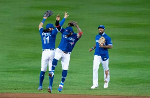 Sep 24, 2020; Buffalo, New York, USA; Toronto Blue Jays designated hitter Bo Bichette (11) and second baseman Jonathan Villar (20) and right fielder Teoscar Hernandez (37) celebrate after clinching a playoff spot following a victory over the New York Yankees at Sahlen Field. Mandatory Credit: Gregory Fisher-USA TODAY Sports