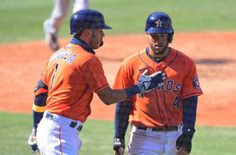 Oct 7, 2020; Los Angeles, California, USA; Houston Astros center fielder George Springer (4) is congratulated by shortstop Carlos Correa (1) after scoring during the fifth inning in game three of the 2020 ALDS against the Oakland Athletics at Dodger Stadium. Mandatory Credit: Jayne Kamin-Oncea-USA TODAY Sports