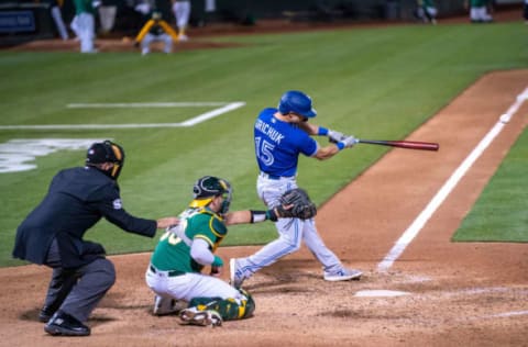 May 5, 2021; Oakland, California, USA; Toronto Blue Jays center fielder Randal Grichuk (15) hits a RBI single during the eighth inning O| at RingCentral Coliseum. Mandatory Credit: Neville E. Guard-USA TODAY Sports