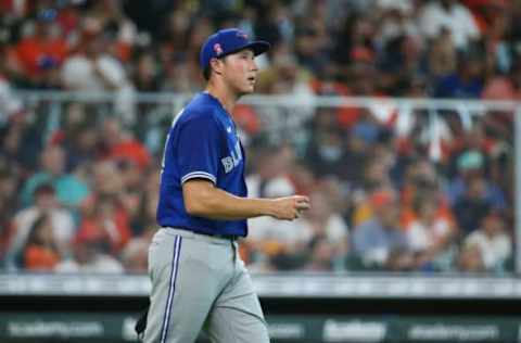 May 9, 2021; Houston, Texas, USA; Toronto Blue Jays starting pitcher Nate Pearson (24) reacts after a pitch during the second inning against the Houston Astros at Minute Maid Park. Mandatory Credit: Troy Taormina-USA TODAY Sports