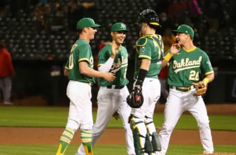 May 27, 2021; Oakland, California, USA; Oakland Athletics starting pitcher Chris Bassitt (40), first baseman Matt Olson (28), catcher Sean Murphy (12) and third baseman Matt Chapman (26) celebrate after Bassitt’s complete game shutout against the Los Angeles Angels at RingCentral Coliseum. Mandatory Credit: Kelley L Cox-USA TODAY Sports