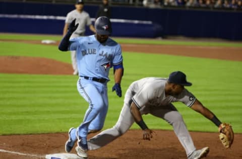 Jun 17, 2021; Buffalo, New York, USA; Toronto Blue Jays shortstop Marcus Semien (10) runs safely to first before the catch by New York Yankees first baseman Chris Gittens (92) during the eighth inning at Sahlen Field. Mandatory Credit: Timothy T. Ludwig-USA TODAY Sports