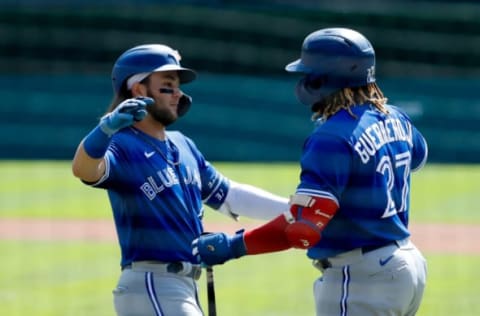 Aug 29, 2021; Detroit, Michigan, USA; Toronto Blue Jays shortstop Bo Bichette (11) receives congratulations from Vladimir Guerrero Jr. (27) after he hits a home run first inning against the Detroit Tigers at Comerica Park. Mandatory Credit: Rick Osentoski-USA TODAY Sports