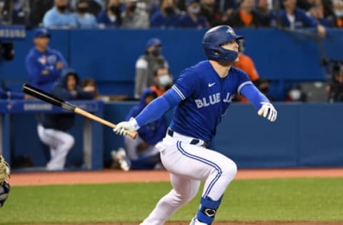 Sep 30, 2021; Toronto, Ontario, CAN; Toronto Blue Jays designated hitter Corey Dickerson (14) hits an RBI single against New York Yankees in the second inning at Rogers Centre. Mandatory Credit: Dan Hamilton-USA TODAY Sports