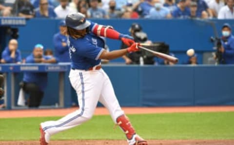 Oct 2, 2021; Toronto, Ontario, CAN; Toronto Blue Jays first baseman Vladimir Guerrero Jr. (27) hits a double against Baltimore Orioles in the sixth inning at Rogers Centre. Mandatory Credit: Dan Hamilton-USA TODAY Sports