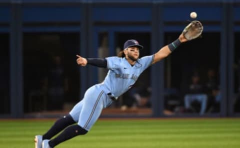 Oct 3, 2021; Toronto, Ontario, CAN; Toronto Blue Jays shortstop Bo Bichette (11) reaches for but misses a ball hit for a single by Baltimore Orioles second baseman Pat Valaika (not shown) in the eighth inning at Rogers Centre. Mandatory Credit: Dan Hamilton-USA TODAY Sports