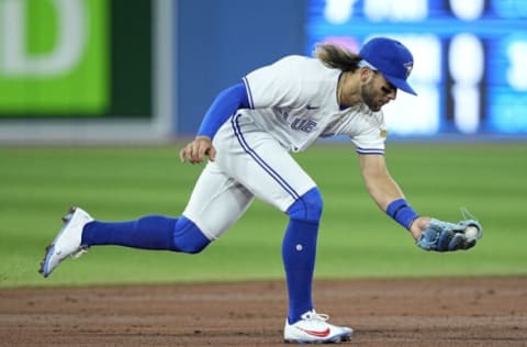 Apr 10, 2022; Toronto, Ontario, CAN; Toronto Blue Jays shortstop Bo Bichette (11) fields a ground ball hit by Texas Rangers baseman Charlie Culberson (not pictured) during the second inning at Rogers Centre. Mandatory Credit: John E. Sokolowski-USA TODAY Sports