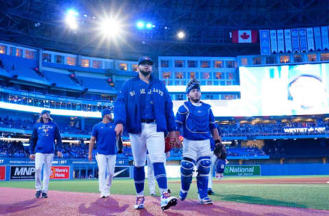 May 3, 2022; Toronto, Ontario, CAN; Toronto Blue Jays pitcher Alek Manoah (center) and catcher Alejandro Kirk (right) head to the dugout before a game against the New York Yankees at Rogers Centre. Mandatory Credit: John E. Sokolowski-USA TODAY Sports