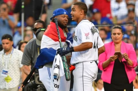 Jul 18, 2022; Los Angeles, CA, USA; Toronto Blue Jays first baseman (27) greets Seattle Mariners center fielder Julio Rodriguez (44) after the final round during the 2022 Home Run Derby at Dodgers Stadium. Mandatory Credit: Gary Vasquez-USA TODAY Sports