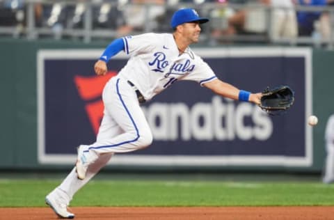 Jul 25, 2022; Kansas City, Missouri, USA; Kansas City Royals second baseman Whit Merrifield (15) flips the ball to first base during the fourth inning against the Los Angeles Angels at Kauffman Stadium. Mandatory Credit: Jay Biggerstaff-USA TODAY Sports