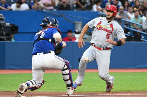 Jul 27, 2022; Toronto, Ontario, CAN; Toronto Blue Jays catcher Danny Jansen (9) takes the throw from the outfield before he tags out St. Louis Cardinals first baseman Albert Pujols (5) at the plate in the fourth inning at Rogers Centre. Mandatory Credit: Dan Hamilton-USA TODAY Sports