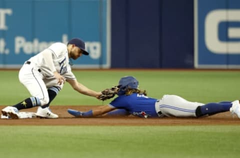 Aug 2, 2022; St. Petersburg, Florida, USA; Tampa Bay Rays second baseman Brandon Lowe (8) tags out Toronto Blue Jays shortstop Bo Bichette (11) as he attempts to steal during the first inning at Tropicana Field. Mandatory Credit: Kim Klement-USA TODAY Sports