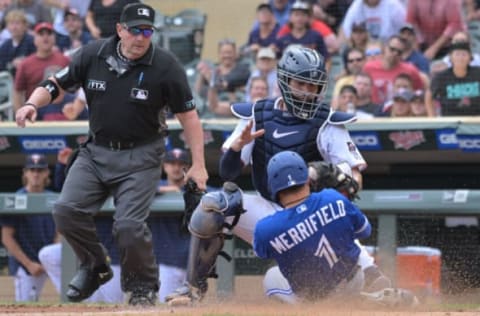 Aug 7, 2022; Minneapolis, Minnesota, USA; Toronto Blue Jays second baseman Whit Merrifield (1) is initially called out by umpire Marty Foster (60) at the plate on a tag by Minnesota Twins catcher Gary Sanchez (24) during the tenth inning at Target Field. Merrifield scored on a sacrifice fly by first baseman Cavan Biggio (not pictured) to left fielder Tim Beckham (not pictured). The call was challenged by the Twins and overturned, ruling Merrifield safe on the play due to the catcher blocking the plate. Mandatory Credit: Jeffrey Becker-USA TODAY Sports