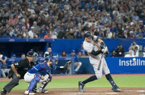 Sep 28, 2022; Toronto, Ontario, CAN; New York Yankees designated hitter Aaron Judge (99) hits his 61st home run scoring two runs against the Toronto Blue Jays during the seventh inning at Rogers Centre. Mandatory Credit: Nick Turchiaro-USA TODAY Sports