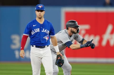 Oct 7, 2022; Toronto, Ontario, CAN; Seattle Mariners right fielder Mitch Haniger (17) reacts from second after hitting a double as Toronto Blue Jays second baseman Whit Merrifield (1) looks on in the eighth inning during game one of the Wild Card series for the 2022 MLB Playoffs at Rogers Centre. Mandatory Credit: Nick Turchiaro-USA TODAY Sports