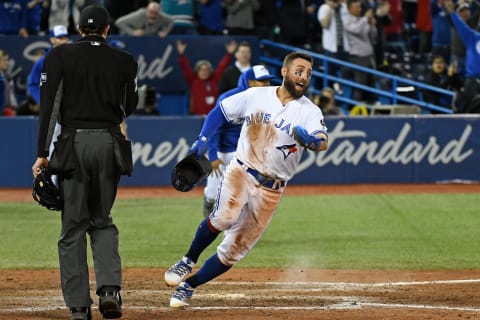 Apr 17, 2018; Toronto, Ontario, CAN; Toronto Blue Jays center field Kevin Pillar (11) crosses home plate after a base hit by catcher Luke Maile in the bottom of the tenth inning during the second game of a double header between the Kansas City Royals and Toronto Blue Jays at Rogers Centre. Mandatory Credit: Gerry Angus-USA TODAY Sports