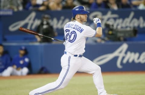 May 11, 2018; Toronto, Ontario, CAN; Toronto Blue Jays third baseman Josh Donaldson (20) hits an RBI single in the first inning against the Toronto Blue Jays at Rogers Centre. Mandatory Credit: John E. Sokolowski-USA TODAY Sports