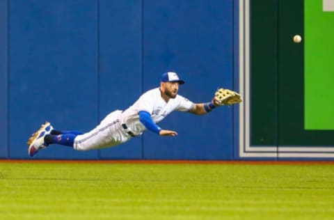 Sep 4, 2018; Toronto, Ontario, CAN; Toronto Blue Jays center fielder Kevin Pillar (11) attempts to catch the ball during the seventh inning against Tampa Bay Rays at Rogers Centre. Mandatory Credit: Kevin Sousa-USA TODAY Sports