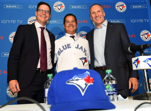 Oct 29, 2018; Toronto, Ontario, Can; Toronto Blue Jays new manager Charlie Montoyo poses for pictures with general manager Ross Atkins (left) and club president Mark Shapiro (right) during an introductory media conference at Rogers Centre. Mandatory Credit: Dan Hamilton-USA TODAY Sports