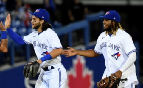 Apr 27, 2021; Dunedin, Florida, CAN; Toronto Blue Jays infielder Vladimir Guerrero Jr. (R) and infielder Bo Bichette (L) celebrate after defeating the Washington Nationals at TD Ballpark. Mandatory Credit: Jonathan Dyer-USA TODAY Sports