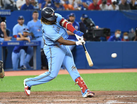 Aug 23, 2021; Toronto, Ontario, CAN; Toronto Blue Jays first baseman Vladimir Guerrero Jr. (27) hits a run scoring double against the Chicago White Sox in the sixth inning at Rogers Centre. Mandatory Credit: Dan Hamilton-USA TODAY Sports