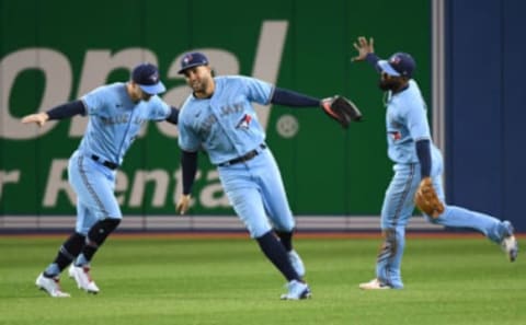 Oct 3, 2021; Toronto, Ontario, CAN; Toronto Blue Jays center fielder George Springer (4, centre) and right fieder Randal Grichuk (15) and left fielder Teoscar Hernandez (37, right) celebrate a win over Baltimore Orioles at Rogers Centre. Mandatory Credit: Dan Hamilton-USA TODAY Sports