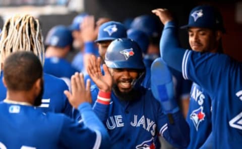 Mar 30, 2022; Tampa, Florida, USA; Toronto Blue Jays right fielder Teoscar Hernandez (37) smiles while celebrating with teammates in the dugout after scoring in the fourth inning against the New York Yankees during spring training at George M. Steinbrenner Field. Mandatory Credit: Jonathan Dyer-USA TODAY Sports