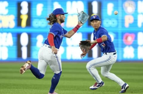 Apr 27, 2022; Toronto, Ontario, CAN; Toronto Blue Jays shortstop Bo Bichette (11) catches a ground ball hit by Boston Red Sox shortstop Xander Bogaerts (not pictured) as Toronto Blue Jays second baseman Gosuke Katoh (29) follows up during the first inning at Rogers Centre. Mandatory Credit: John E. Sokolowski-USA TODAY Sports