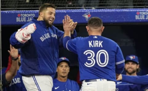 May 3, 2022; Toronto, Ontario, CAN; Toronto Blue Jays starting pitcher Alek Manoah (left) congratulates catcher Alejandro Kirk (30) on scoring a run against the New York Yankees during the fifth inning at Rogers Centre. Mandatory Credit: John E. Sokolowski-USA TODAY Sports