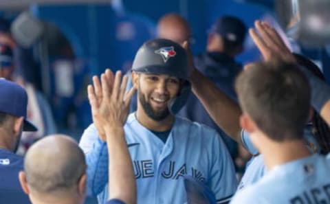 Aug 14, 2022; Toronto, Ontario, CAN; Toronto Blue Jays left fielder Lourdes Gurriel Jr. (13) celebrates in the dugout after scoring a run against the Cleveland Guardians during the first inning at Rogers Centre. Mandatory Credit: Nick Turchiaro-USA TODAY Sports