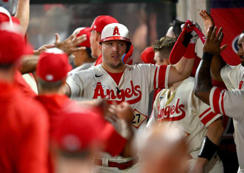 Sep 29, 2022; Anaheim, California, USA; Los Angeles Angels center fielder Mike Trout (27) is greeted after scoring a run in the first inning against the Oakland Athletics at Angel Stadium. Mandatory Credit: Jayne Kamin-Oncea-USA TODAY Sports