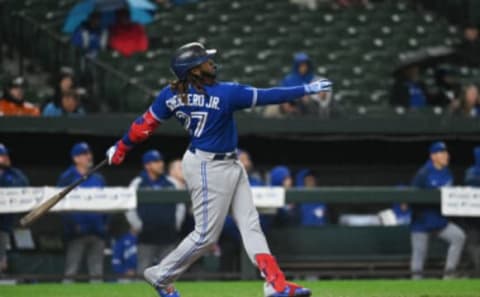 Oct 3, 2022; Baltimore, Maryland, USA; Toronto Blue Jays first baseman Vladimir Guerrero Jr. (27) hits a second inning solo home run against the Baltimore Orioles at Oriole Park at Camden Yards. Mandatory Credit: Tommy Gilligan-USA TODAY Sports