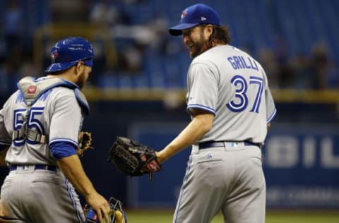 Apr 6, 2017; St. Petersburg, FL, USA; Toronto Blue Jays relief pitcher Jason Grilli (37) and Toronto Blue Jays catcher Russell Martin (55) congratulate each other after they beat the Tampa Bay Rays at Tropicana Field. Toronto Blue Jays defeated the Tampa Bay Rays 5-2. Mandatory Credit: Kim Klement-USA TODAY Sports