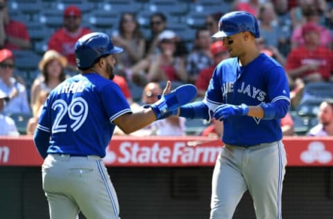 Apr 23, 2017; Anaheim, CA, USA; Toronto Blue Jays second baseman Ryan Goins (right) celebrates with second baseman Devon Travis (29) after hitting a two-run home run against the Los Angeles Angels in the 9th inning at Angel Stadium of Anaheim. Mandatory Credit: Richard Mackson-USA TODAY Sports