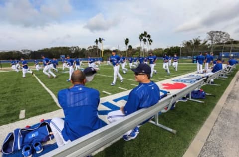 Feb 15, 2017; Dunedin, FL, USA; Toronto Blue Jays manager John Gibbons (5) talks as he watches pitchers and catchers warm up before the first workout at Cecil P. Englebert Recreation Complex. Mandatory Credit: Kim Klement-USA TODAY Sports