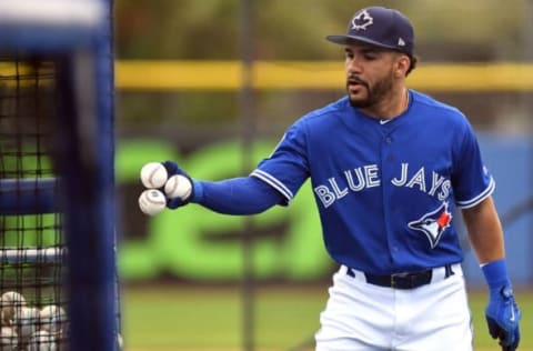 Feb 23, 2017; Dunedin, FL, USA; Toronto Blue Jays infielder Devon Travis (29) picks up baseballs after taking batting practice during the spring training workout at Florida Auto Exchange Stadium. Mandatory Credit: Jonathan Dyer-USA TODAY Sports