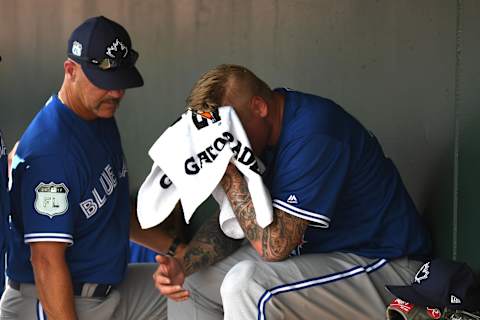 Mar 8, 2017; Sarasota, FL, USA; Toronto Blue Jays pitching coach Pete Walker (40) talks to Toronto Blue Jays pitcher Mat Latos (57) after he gave up a three run home run in the second inning of the spring training game against the Baltimore Orioles at Ed Smith Stadium. Mandatory Credit: Jonathan Dyer-USA TODAY Sports