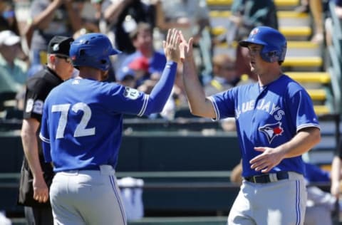 Mar 19, 2017; Bradenton, FL, USA; Toronto Blue Jays catcher Mike Ohlman (43) and outfielder JB Woodman (72) score runs during the sixth inning against the Pittsburgh Pirates at McKechnie Field. Mandatory Credit: Kim Klement-USA TODAY Sports