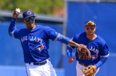 Mar 22, 2017; Dunedin, FL, USA; Toronto Blue Jays third baseman Ryan Goins (17) throws to first base for an out on Detroit Tigers center fielder JaCoby Jones (40) in the fifth inning of a baseball game during spring training at Florida Auto Exchange Stadium. Mandatory Credit: Butch Dill-USA TODAY Sports