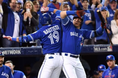 Oct 4, 2016; Toronto, Ontario, CAN; Toronto Blue Jays right fielder Jose Bautista (19) celebrates with Toronto Blue Jays shortstop Troy Tulowitzki (2) after hitting a solo home run during the second inning against the Baltimore Orioles in the American League wild card playoff baseball game at Rogers Centre. Mandatory Credit: Nick Turchiaro-USA TODAY Sports